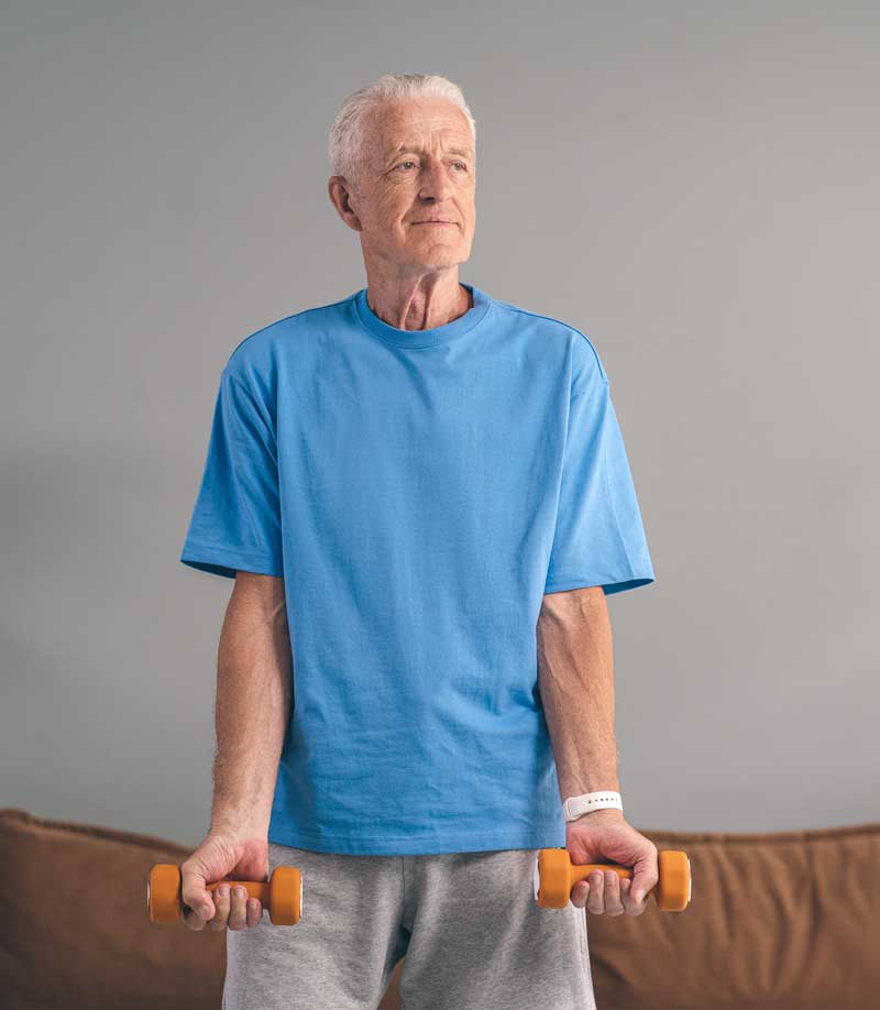 Photo by SHVETS production: https://www.pexels.com/photo/an-elderly-man-in-blue-shirt-holding-a-dumbbells-8899509/